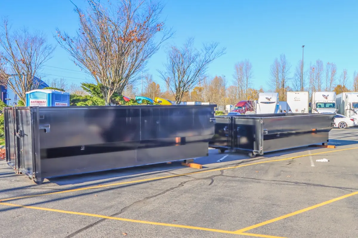 Professional dumpster rental service with roll-off container on residential driveway in Lindenwold